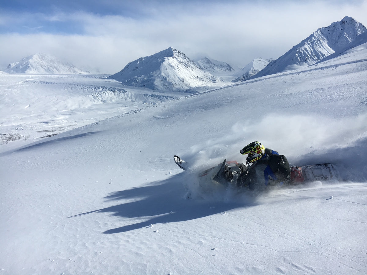 Snowmobile riding in the Alaska mountains