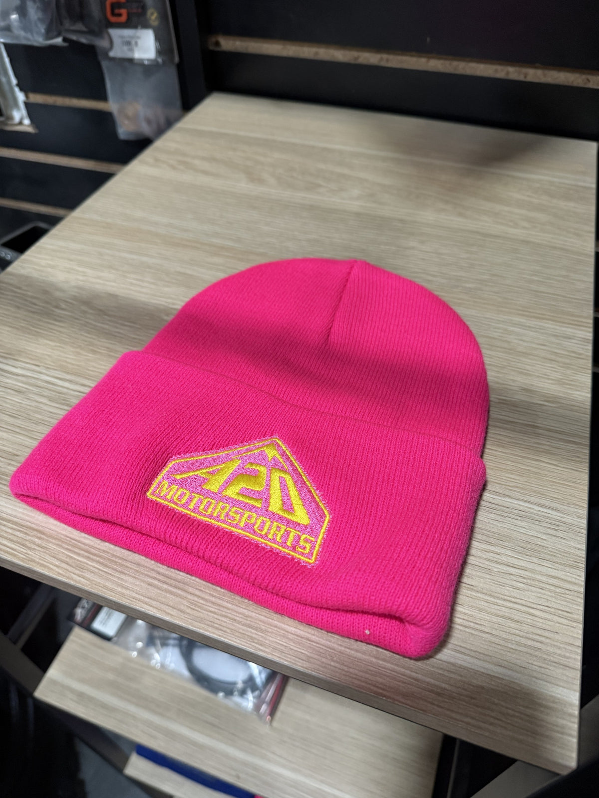 A2D Motorsports cuffed knit beanie in pink with gold embroidered mountain logo