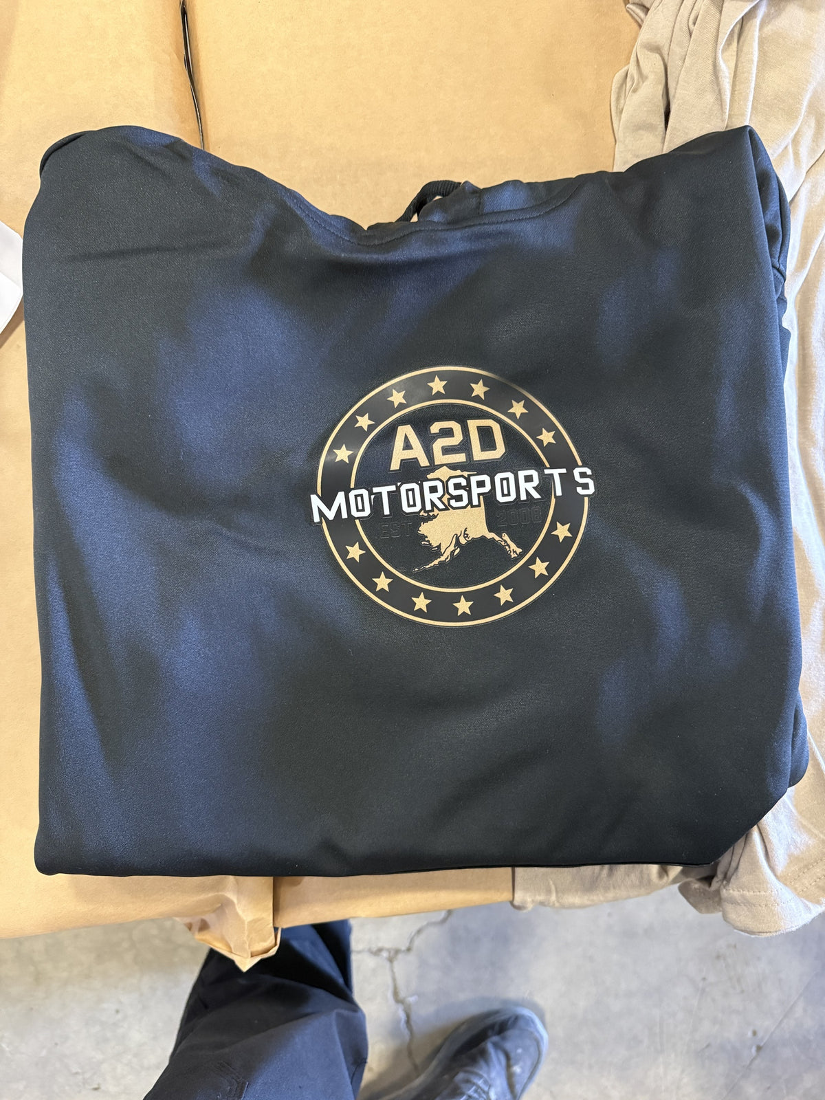 A2D Motorsports black hoodie with the gold Stars and State Alaska logo