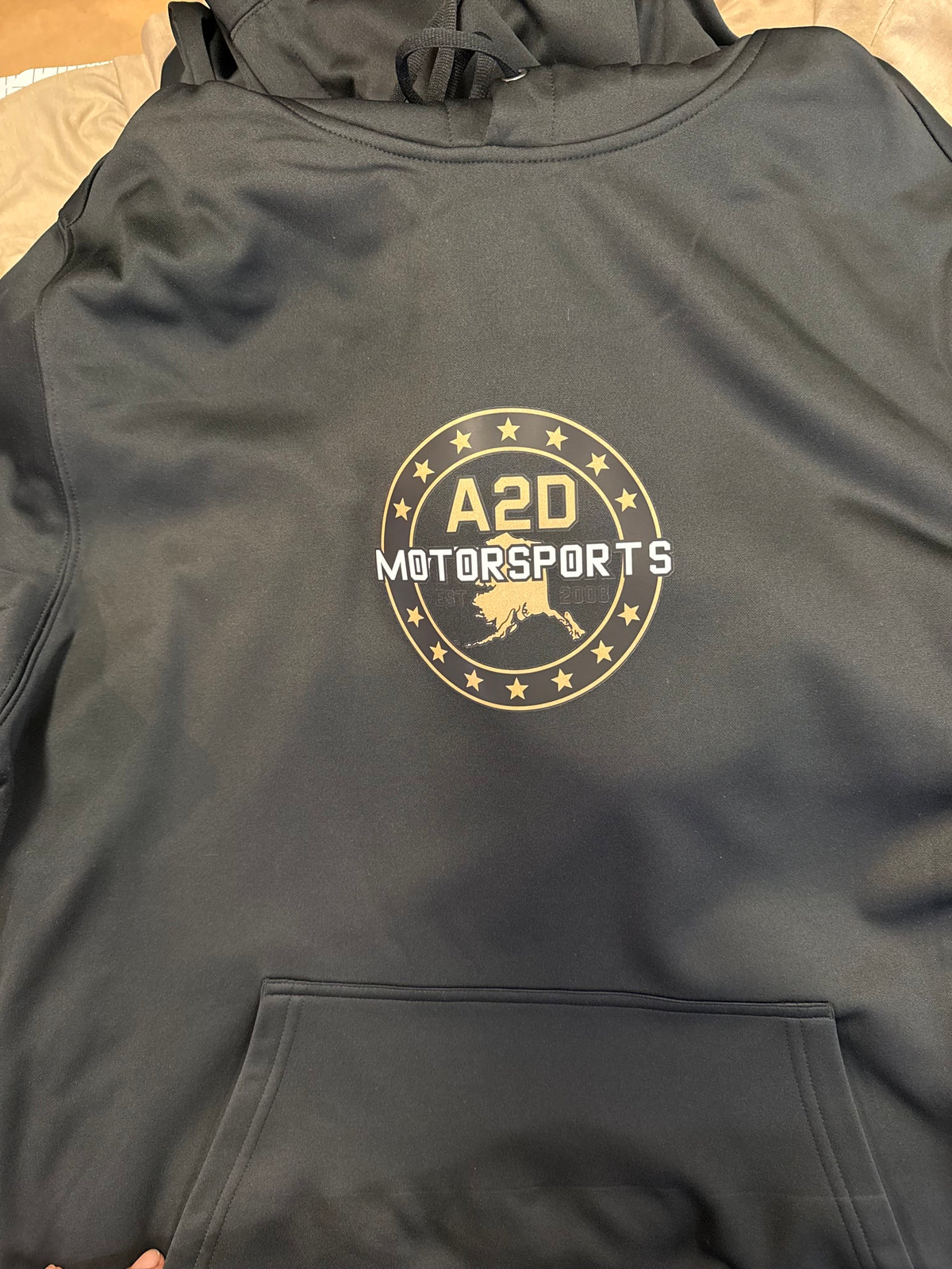 A2D Motorsports hoodie in black with gold Stars and State Alaska logo and front pouch pocket
