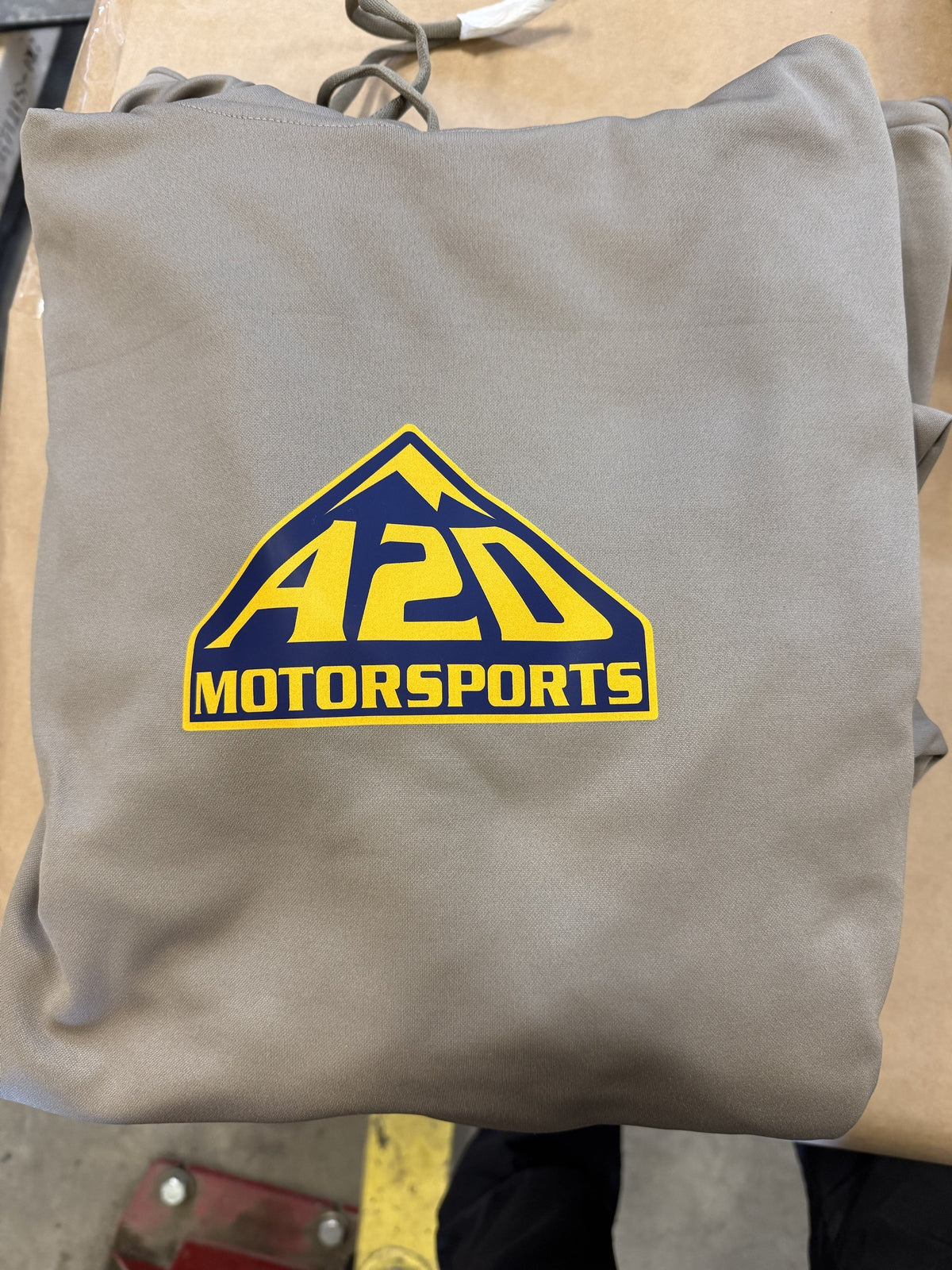 A2D Motorsports sand hoodie with the blue and gold mountain logo