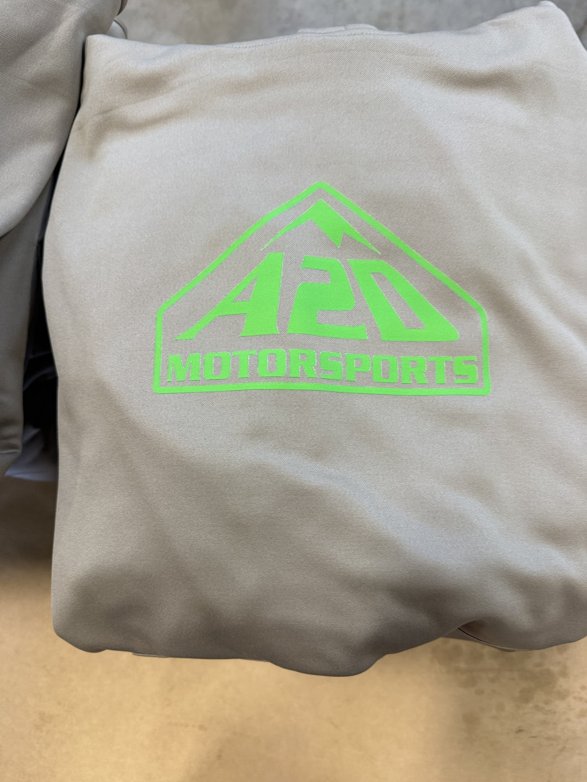A2D Motorsports sand hoodie with the green mountain logo