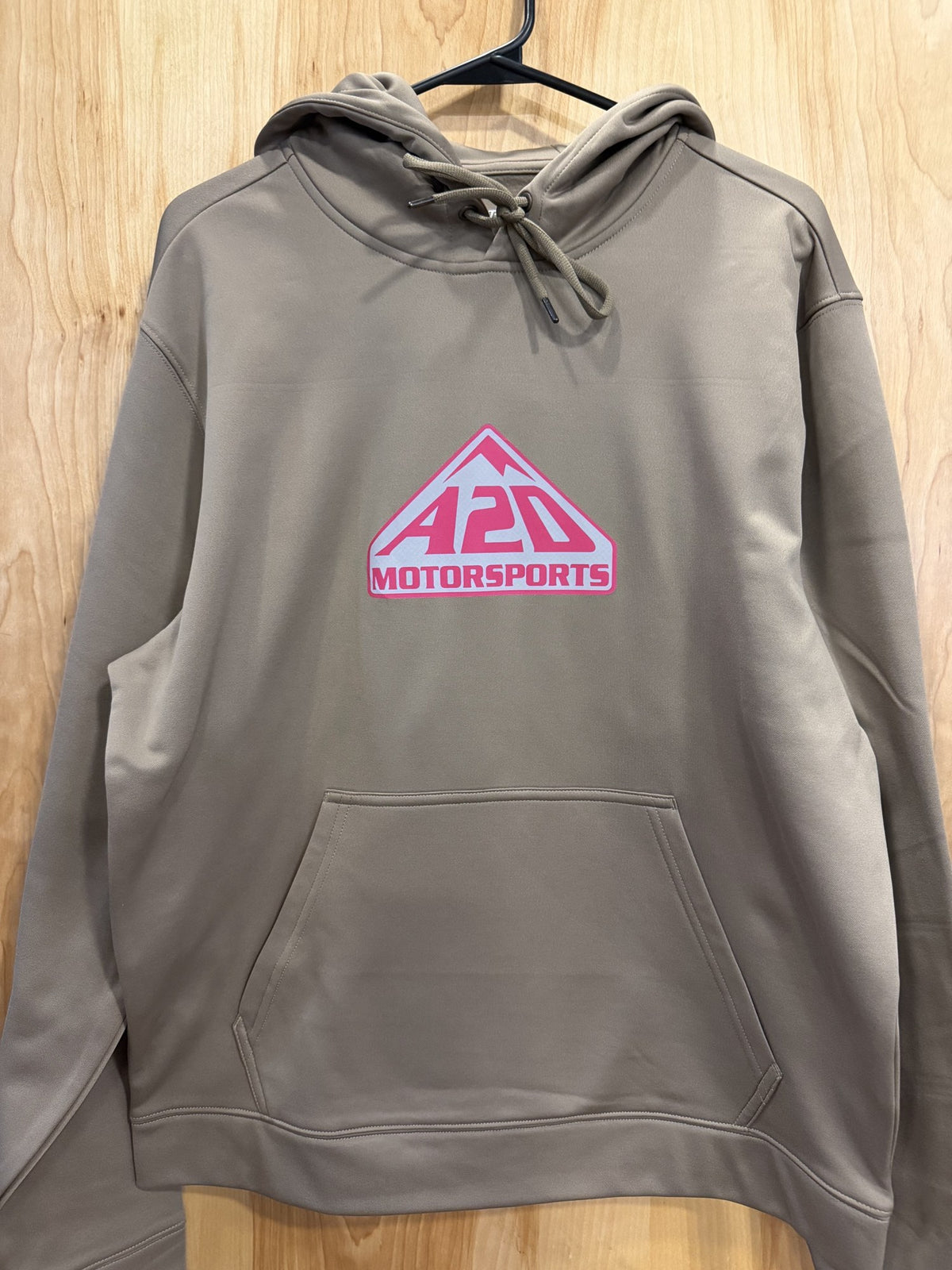 A2D Motorsports sand hoodie with pink and white mountain logo, hanging